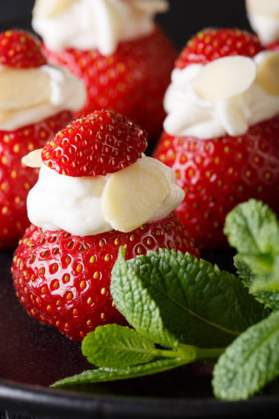 istock Fresh strawberry stuffed with whipped cream and almond macro. vertical 991949880