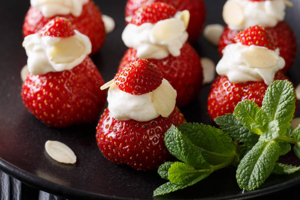 istock Organic strawberry stuffed with whipped cream, almonds and mint closeup. horizontal 991949948