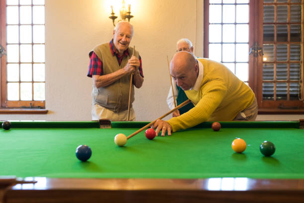 istock Young seniorman playing snooker confident in getting this shot! 991971090
