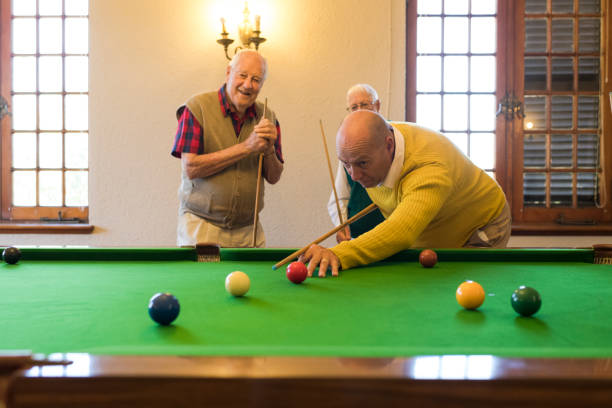 istock Having some fun at the snooker table while watching a friend taking a shot 991971256
