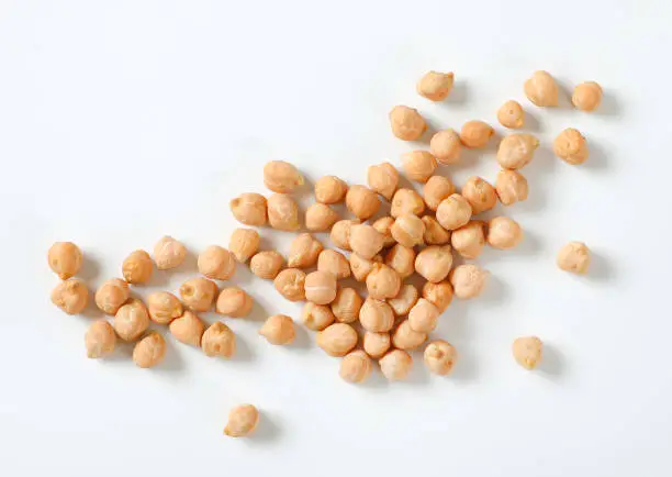 handful of raw chickpeas on white background