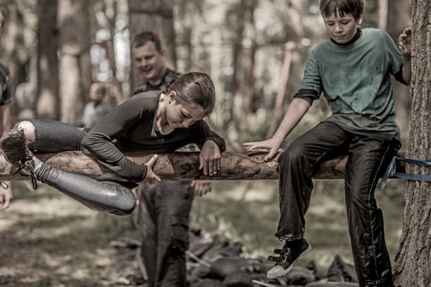 istock Family having sporty fun at a public mud run obstacle course 991971772
