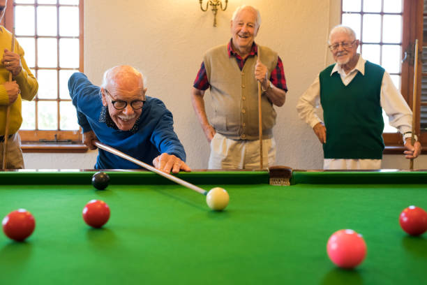 istock Four mature men ready for a game of snooker 991971932
