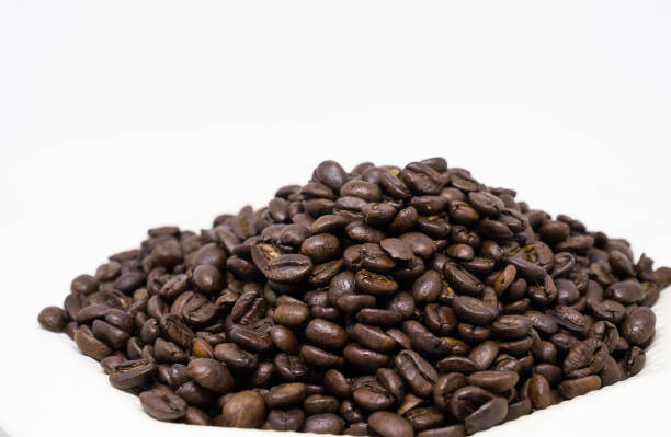 istock close up of coffee beans isolated on white background 991978102