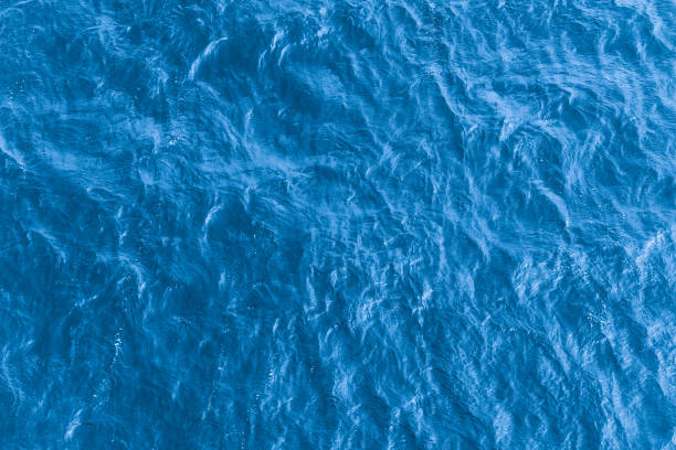 istock Beautiful sea background - blue water surface with small ripples, top view 991978380