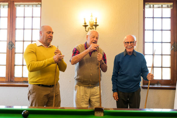 istock Senior men each holding a cue stick 991979040