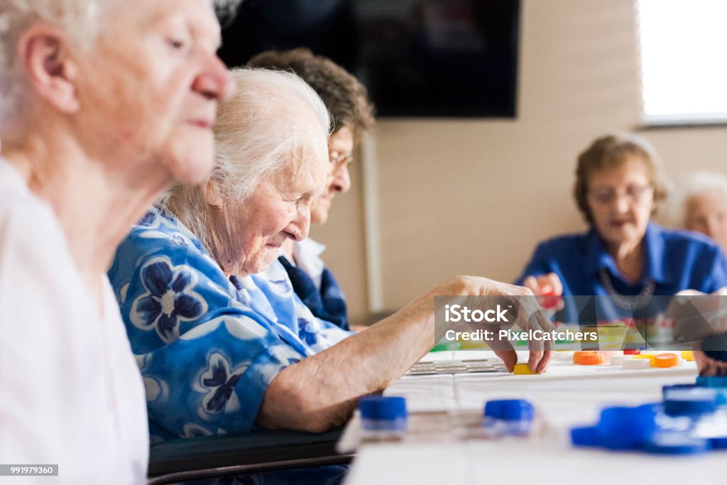 Senior ladies at a table playing bingo Bingo Stock Photo