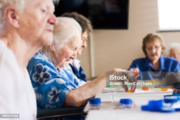 Senior Ladies At A Table Playing Bingo Stock Photo - Download Image Now - Bingo, Community, Nursing Home