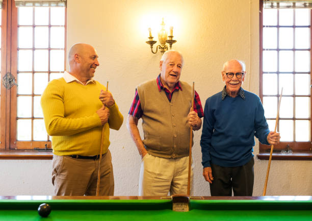 istock Senior friends about to begin a game of pool 991979636