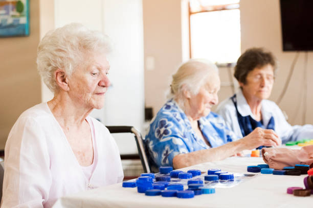 istock Senior women playing at bingo table in nursing home 991982414