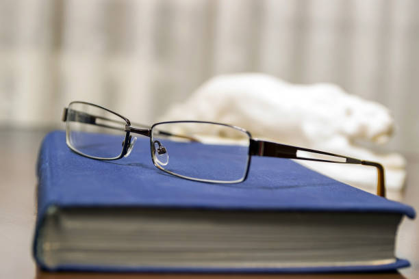 istock Blue book and glasses. Eyewear on the book. 991983918