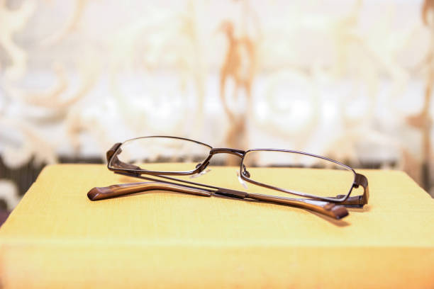 istock Yellow book and glasses. 991984004