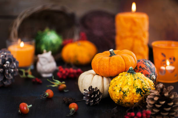 istock Autumnal colorful  pumpkins  on candle and fallen leaves background 991994190