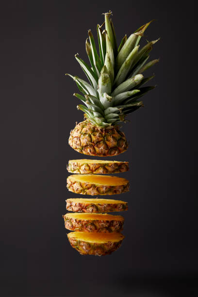 istock close up view of cut ripe pineapple isolated on black 991998034