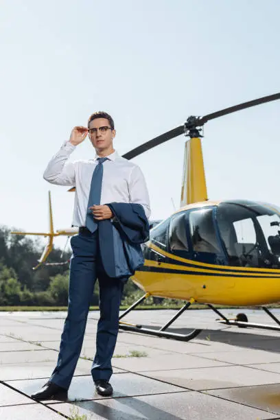 Photo of Handsome young businessman checking out heliport condition
