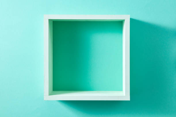 Simple green wood box shelf in the form of a square isolated on a wall of mint color. Product display template