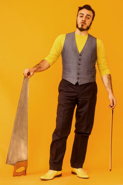 istock Man portrait posing while holding his musical saw 992003772