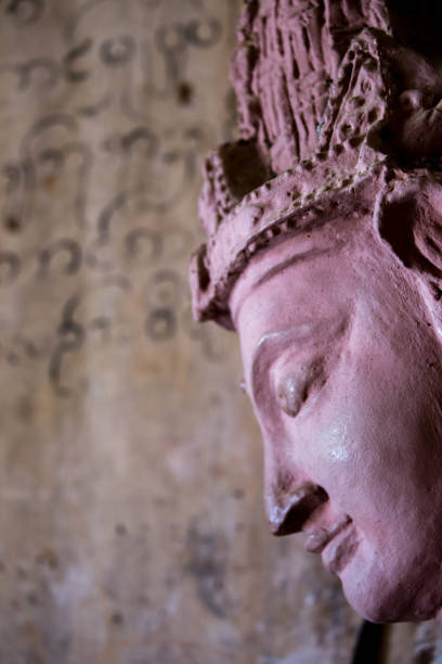 Myanmar: Dhammayazika Pagoda The face of a statue with a fresco of an ancient text in the background at the Dhammayazika Pagoda (Dhamma Ya Zi Ka Pagoda) in Bagan. dhammayazika pagoda stock pictures, royalty-free photos & images