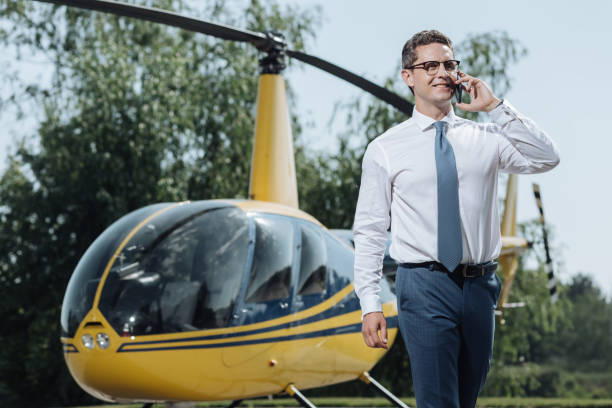 istock Pleasant CEO discussing details with partners at helipad 992006430