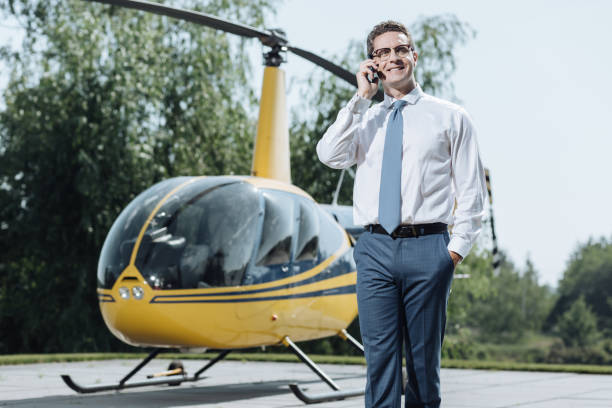 istock Handsome helicopter owner communicating on phone 992006822