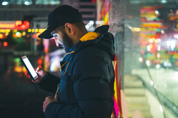 istock Man on bus stop busy on phone while waiting for bus. 992006990