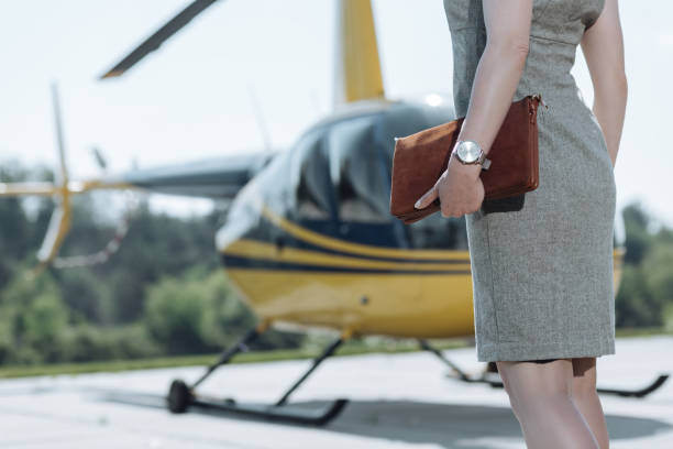 istock Slender young female holding brown bag at heliport 992008152