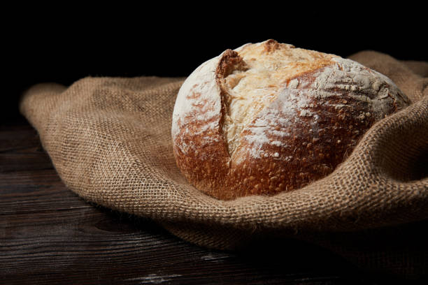 istock close up shot of bread and sackcloth on rustic wooden table 992009054
