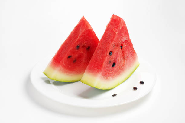 Slices of watermelon in plate on white background