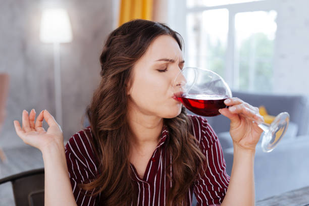 istock Dark-haired woman drinking wine after stress 992011580