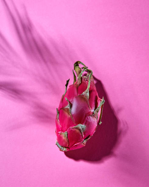 istock Dragon fruit or Pitahaya isolated on a pink background. Top view 992012922
