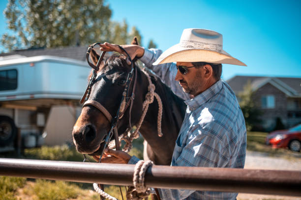istock Cowboy getting ready for riding in rodeo arena 992012996