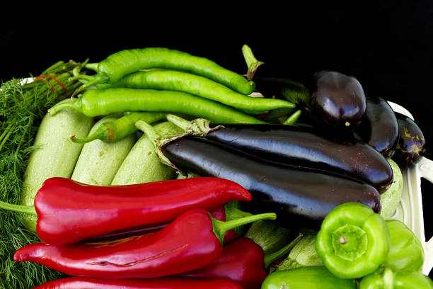 istock summer vegetables on the black back ground,on a black background summer vegetables, zucchini, eggplant, peppers and dill, 992015878