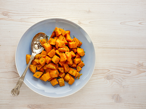 Home made freshness roasted sweet potatoes cubes with fine chopped chives