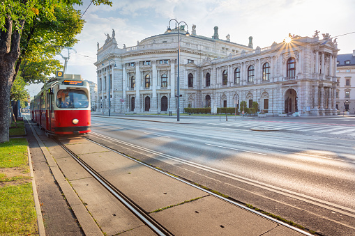 Cityscape image of Vienna with the Burgtheater and the Ring Road during sunrise.