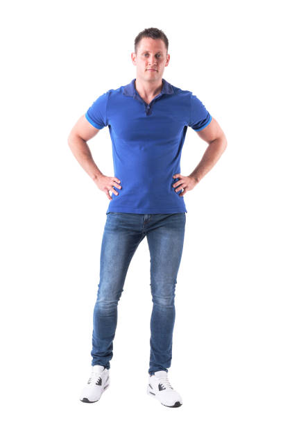 istock Serious confident fit man in casual clothes with hands on hips looking at camera 992017580