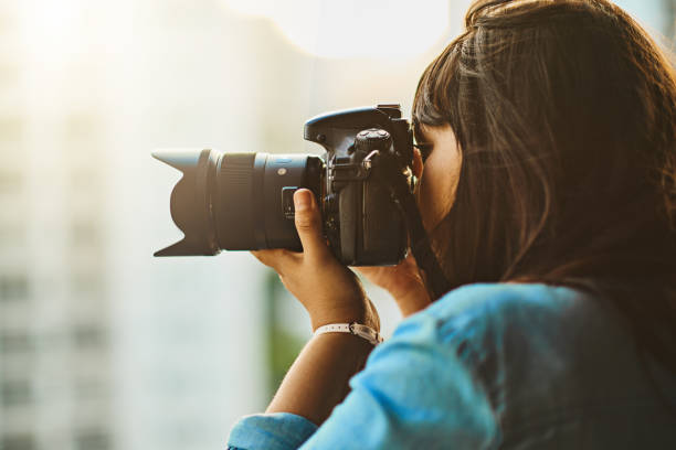 Seeing and capturing the world Shot of a woman taking pictures with her camera outside digital camera photos stock pictures, royalty-free photos & images