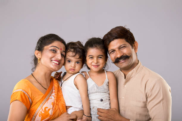 Indian family Portrait of Indian parents with little kids happy indian young family couple stock pictures, royalty-free photos & images
