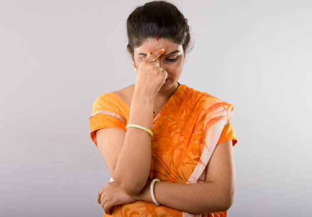 Frustrated Indian woman with head in hands