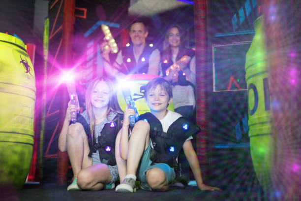 istock Kids sitting in beams with laser guns 992025170