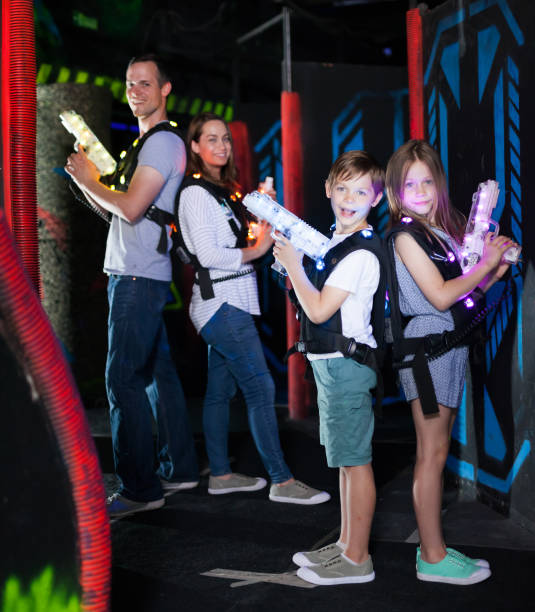 istock Kids standing back to back with laser pistols 992025258