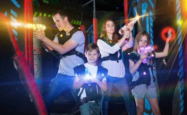 istock Kids and parents in beams during laser tag game 992025266