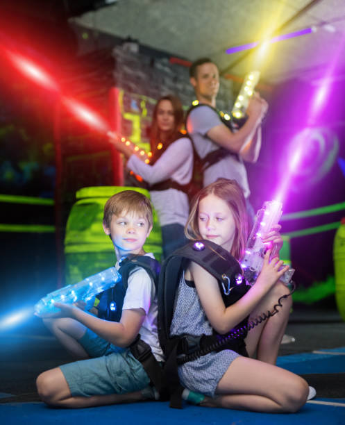 istock Kids sitting back to back in laser beams 992025278