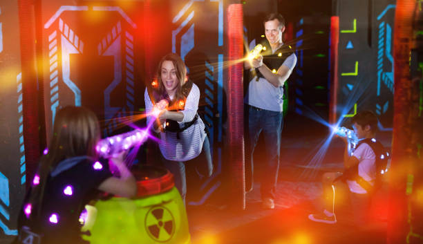 istock Kids and parents in beams during laser tag game 992025326
