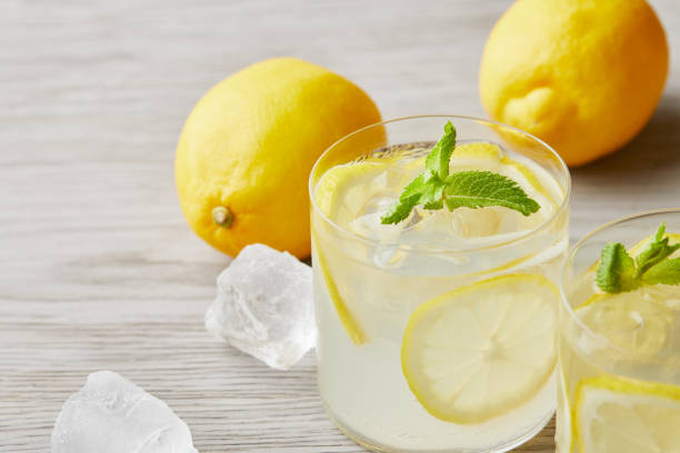 istock cooled lemonade glasses with ripe lemons on wooden surface 992028434