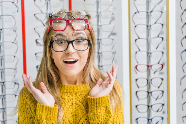 istock young shocked girl choosing eyeglasses in optics 992032606