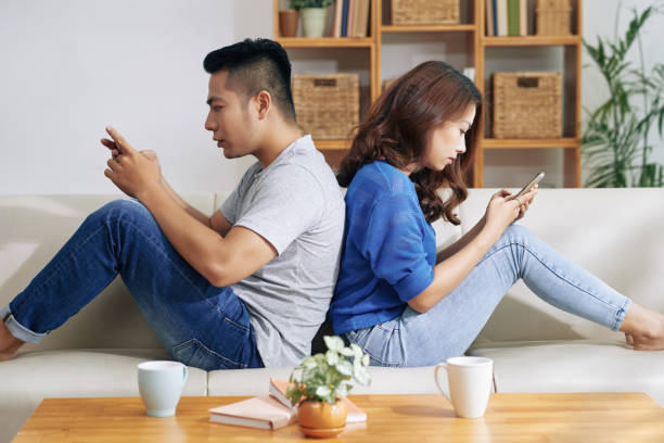 istock Ethnic couple separated with gadgets 992033142