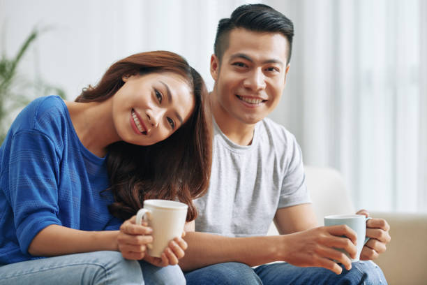 istock Wonderful young ethnic couple with mugs 992033182