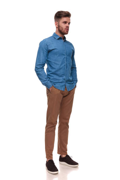 istock relaxed casual man standing looks to side 992033230