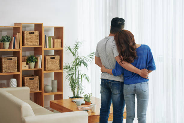 istock Embracing couple standing in living room 992033284