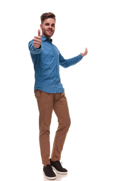 istock handsome casual man makes ok sign and presents behind 992033340